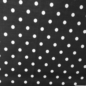 May include: Black and white polka dot fabric with white dots on a black background.