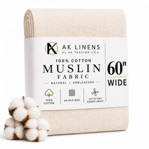 May include: A folded bolt of natural unbleached 100% cotton muslin fabric, 152 cm wide, with a paper label reading AK Linens by AK Trading Co. and featuring icons for cotton, width, and length, accompanied by three white cotton bolls.