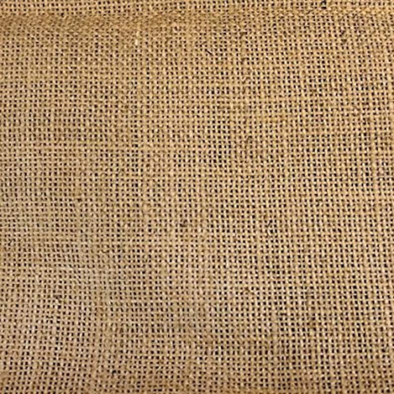May include: A close-up of a brown burlap fabric with a woven texture.