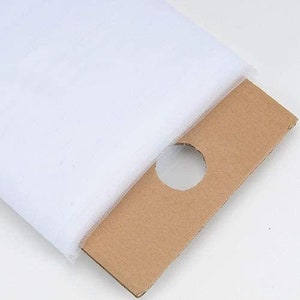 May include: A roll of white tulle fabric, a sheer and delicate material often used for crafting, decorating, and special occasions.