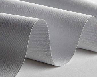 May include: Close-up of a white fabric with a textured surface. The fabric is folded and has a soft, smooth feel.
