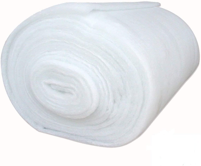 May include: A white roll of polyester fiberfill batting, commonly used for stuffing crafts, pillows, and other projects.