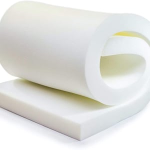May include: A white foam mattress topper rolled up for easy storage. The topper is thick and dense, providing extra comfort and support.