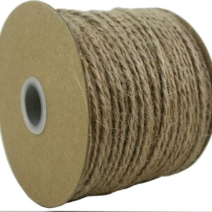 May include: A roll of natural brown twine or jute rope on a cardboard spool. The twine is tightly wound and ready for crafting, wrapping, or decorating.