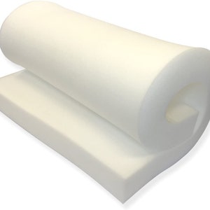 May include: A white foam cushion rolled up and ready to be used for upholstery or crafting projects.