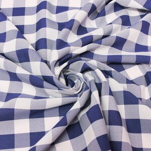 May include: Blue and white gingham fabric with a checkered pattern. The fabric is folded and twisted, creating a swirling effect.