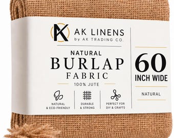 May include: A folded roll of natural tan burlap fabric wrapped in a white paper band labeled AK LINENS by AK TRADING CO. NATURAL BURLAP FABRIC 100% JUTE 60 INCH WIDE. The band features icons for natural, durable, and craft use with loose fibers below.
