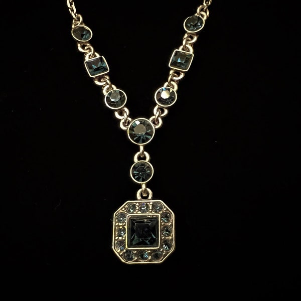 Givenchy silver tone adjustable chain necklace w a Y pendant decorated with sapphire colored round and square faceted crystals w snap lock.