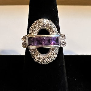 Vintage sterling silver marcasite and amethyst ring with a large marcasite oval and 4 square amethyst stone running through the center, US 9