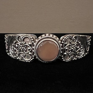 Suarti Bali Sterling silver 925 artisan adjustable cuff with scrolls and swirls and a center round bezel set mother of pearl stone.