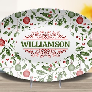 May include: Oval serving platter with a festive Christmas design. The white platter features a holly and ornament pattern with red and green accents. The word "WILLIAMSON" is displayed in the center.