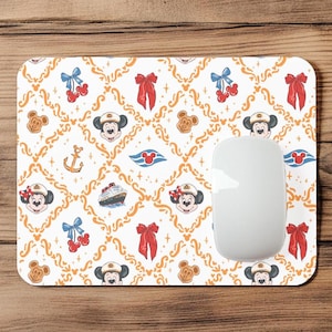 May include: White rectangular mousepad with a repeating pattern of Mickey and Minnie Mouse, bows, cherries, anchors, and cruise ships. The design is set against a gold filigree background. A white computer mouse is on the right side.