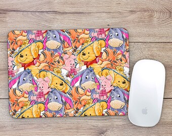 May include: A colorful mouse pad featuring a repeating pattern of Winnie the Pooh and Tigger characters. The characters are drawn in a cartoon style and are surrounded by a yellow and orange background.