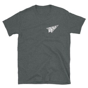 May include: A dark heather grey t-shirt with a white paper airplane graphic. The airplane is made of a detailed pattern.