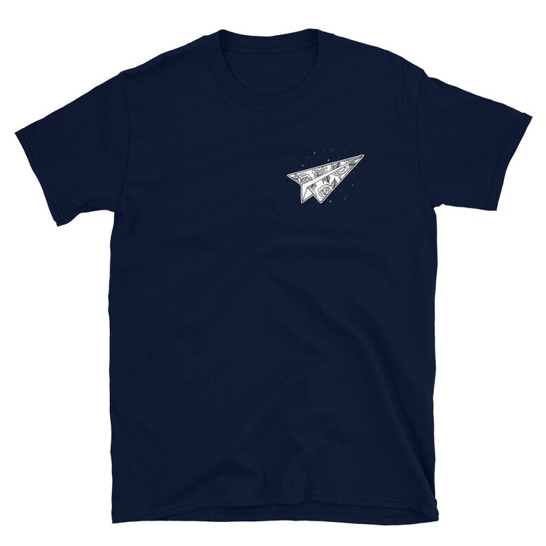 May include: A navy blue t-shirt with a white paper airplane graphic. The airplane is folded and has a detailed design.