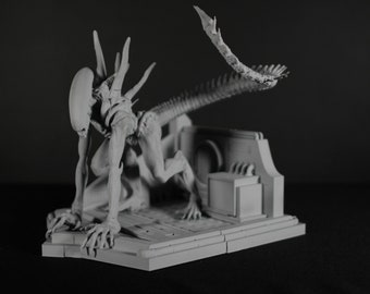 May include: A gray, detailed, articulated, plastic model of an alien creature with a long, segmented tail. The creature is posed in a crouched position with its head lowered. The model is displayed on a gray, multi-level base.