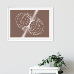 May include: A framed print featuring a white abstract design on a brown background. The design consists of overlapping circles.
