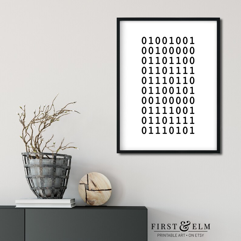 May include: A black and white printable art print with a minimalist design featuring a series of binary code numbers. The print is framed in a black frame and is displayed on a white wall.