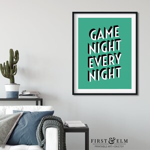 May include: A teal green printable art print with the text "GAME NIGHT EVERY NIGHT" in white and black 3D lettering. The print is framed in a black frame.