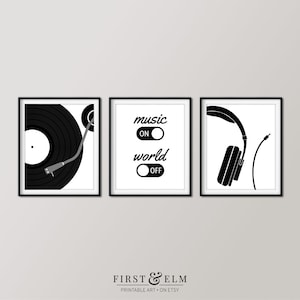 May include: Three framed black and white prints. The left print shows a vinyl record and turntable. The center print has the text "music ON world OFF". The right print features a pair of headphones. The prints are minimalist and modern.