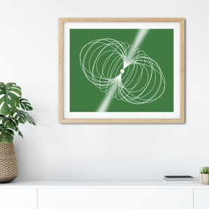 May include: A framed abstract art print featuring a white geometric design on a green background.
