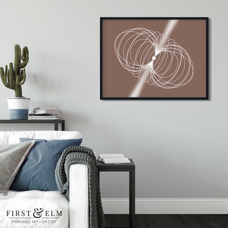 May include: A digital art print featuring a white abstract design on a brown background. The design is a series of overlapping circles and lines, creating a sense of movement and energy. The print is framed in a black frame.