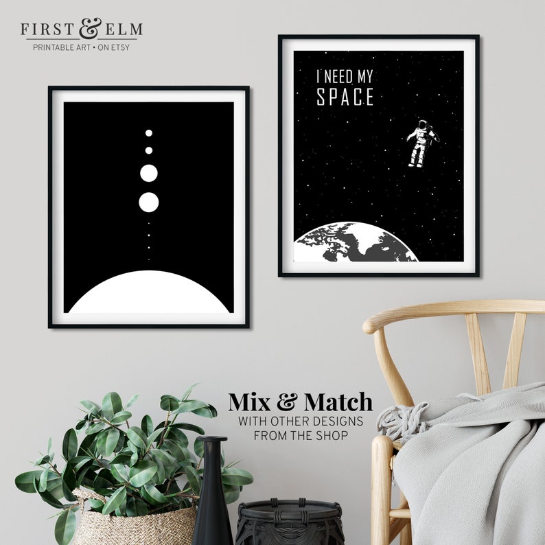 May include: Two black and white printable art prints with space themes. The first print features a stylised image of a planet with a ring and several smaller planets. The second print features an astronaut floating in space above the Earth with the text "I need my space".