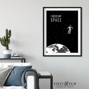 May include: Black and white printable art print featuring an astronaut floating in space above the Earth with the text "I need my space".