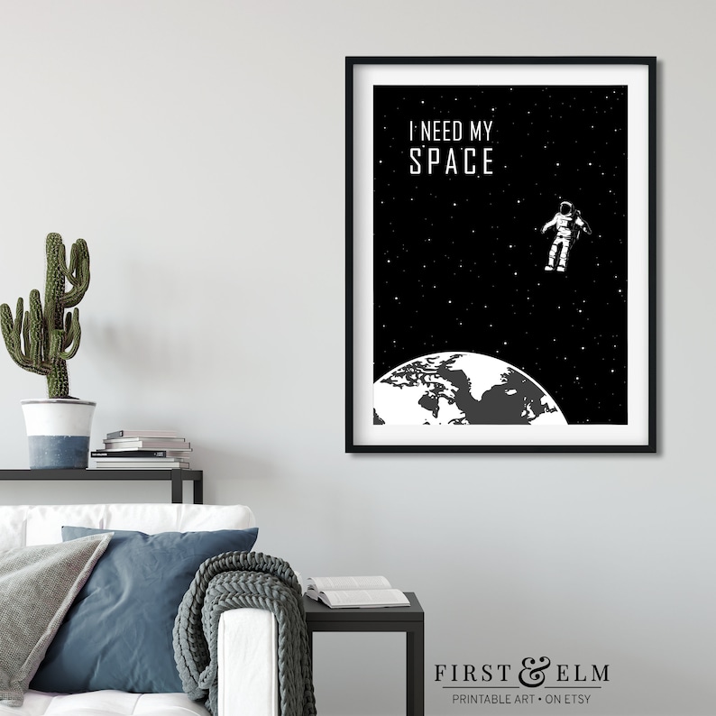 May include: Black and white printable art print featuring an astronaut floating in space above the Earth with the text "I need my space".