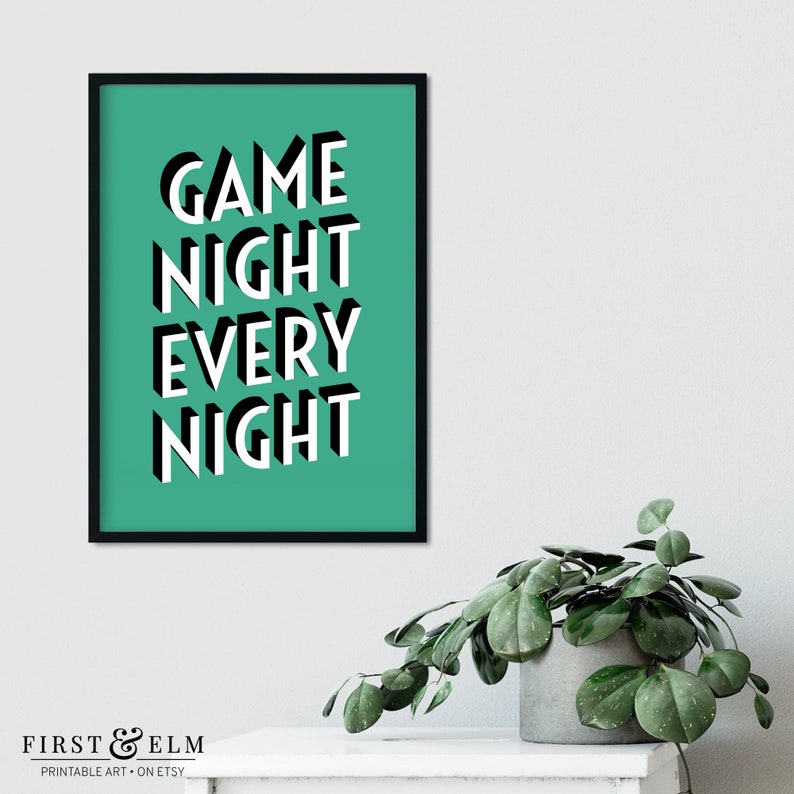 May include: A teal green printable wall art print with black framing. The print features the text "GAME NIGHT EVERY NIGHT" in white 3D block letters.