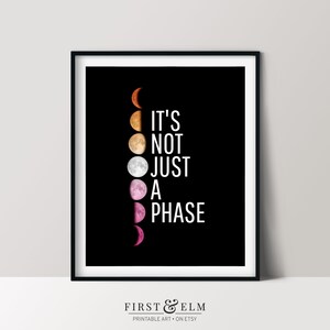 May include: A black and white printable art print with a graphic of a moon in different phases. The text "It's not just a phase" is written in white on a black background.