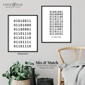 May include: Two black framed prints with white backgrounds and black text. The text is in binary code and translates to "Shannon" and "I love you". The prints are hanging on a light gray wall. The text "Mix & Match" is below the prints, along with the text "With other designs from the shop".