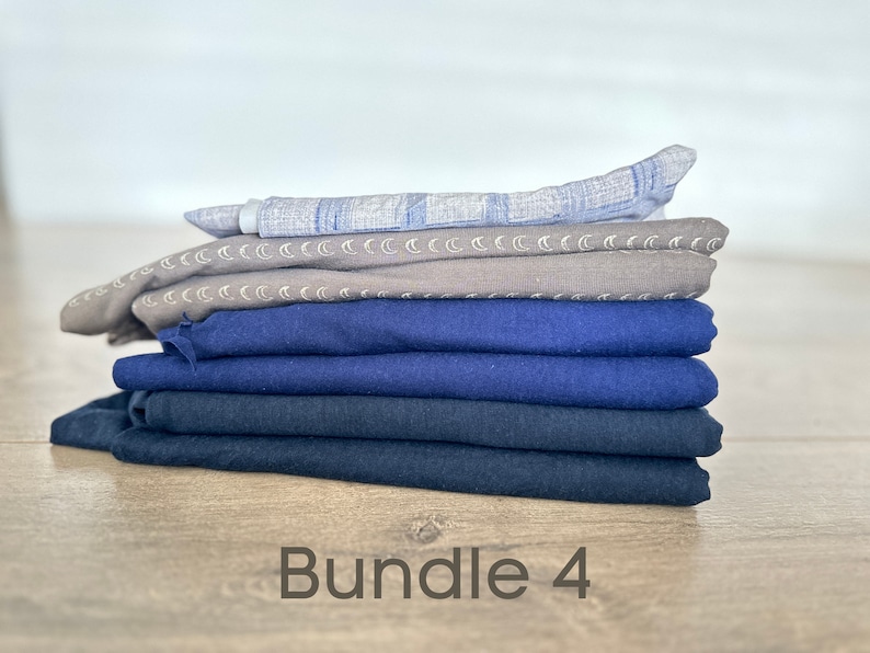 May include: A stack of six fabric squares in various shades of blue and gray. The top square has a light blue and white pattern. The second square has a gray background with a white crescent moon pattern. The bottom four squares are various shades of blue. The text "Bundle 4" is written below the stack of fabric.