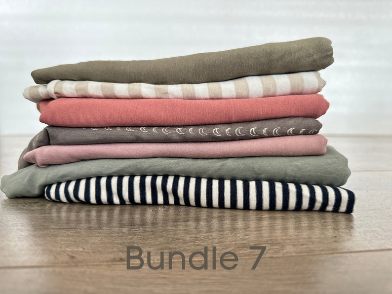 May include: A stack of seven fabric swatches in various colors and patterns, including striped, solid, and patterned. The swatches are folded neatly and labeled "Bundle 7".