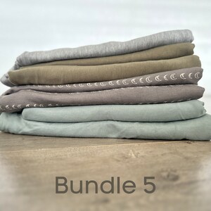 May include: A stack of five fabric squares in various shades of green and gray. The fabric squares have a subtle pattern of white crescent moons. The text "Bundle 5" is printed below the stack of fabric.