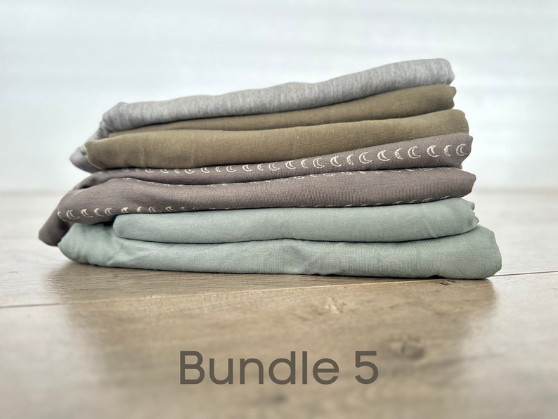 May include: A stack of five fabric squares in various shades of green and gray. The fabric squares have a subtle pattern of white crescent moons. The text "Bundle 5" is printed below the stack of fabric.