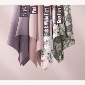 May include: Four fabric swatches hanging from the top of the image. The swatches are labeled "Purple", "Pink", "Pink & White Floral", and "Grey Floral".