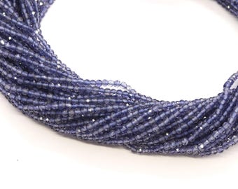May include: A strand of blue gemstone beads, likely kyanite, with a faceted finish. The beads are small and uniform in size, creating a delicate and elegant look.