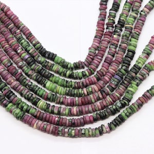 May include: A strand of green and pink gemstone beads. The beads are round and have a smooth, polished finish.