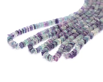 May include: A strand of multi-colored gemstone beads. The beads are faceted and have a square shape. The colors of the beads are purple, green, and blue.