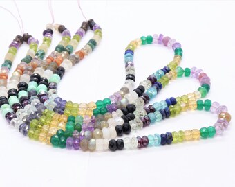 May include: A collection of colorful gemstone beads, including amethyst, aquamarine, citrine, emerald, garnet, labradorite, moonstone, peridot, and sapphire. The beads are strung on a cord and are ready to be used for jewelry making.