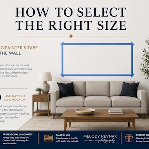 May include: A room setting with a beige sofa, black pillows, and a wooden coffee table. The text "HOW TO SELECT THE RIGHT SIZE" is at the top. Blue painter's tape outlines a rectangle on the wall, demonstrating how to visualize art sizes.