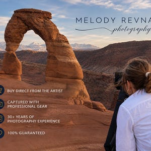 May include: A scenic landscape photograph featuring a natural rock arch under a blue sky. The image includes the text "MELODY REVNAK photography". Additional text states "BUY DIRECT FROM THE ARTIST", "CAPTURED WITH PROFESSIONAL GEAR", "30+ YEARS OF PHOTOGRAPHY EXPERIENCE", and "100% GUARANTEED".