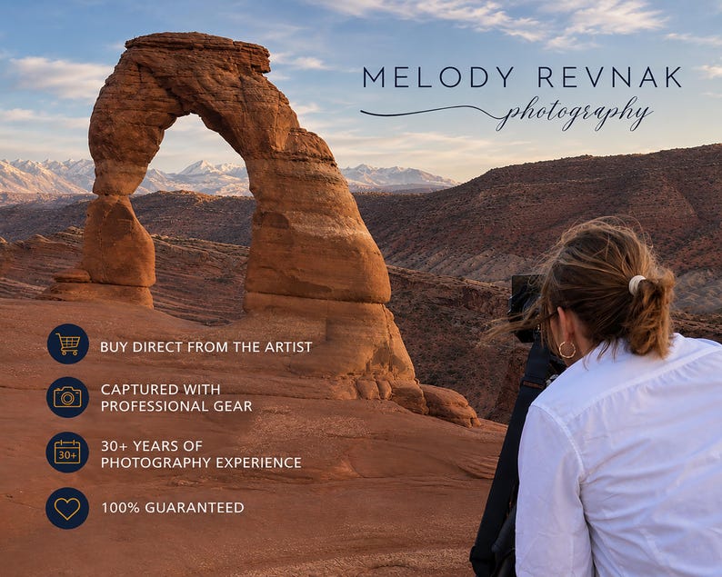 May include: A scenic landscape photograph featuring a natural rock arch under a blue sky. The image includes the text "MELODY REVNAK photography". Additional text states "BUY DIRECT FROM THE ARTIST", "CAPTURED WITH PROFESSIONAL GEAR", "30+ YEARS OF PHOTOGRAPHY EXPERIENCE", and "100% GUARANTEED".
