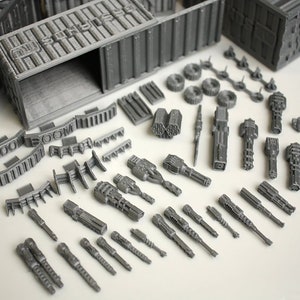 May include: A set of grey plastic model pieces for a miniature war game. The set includes a variety of weapons, including cannons, missile launchers, and other futuristic weaponry. The set also includes a container with the word "SUPPLY" printed on the side.