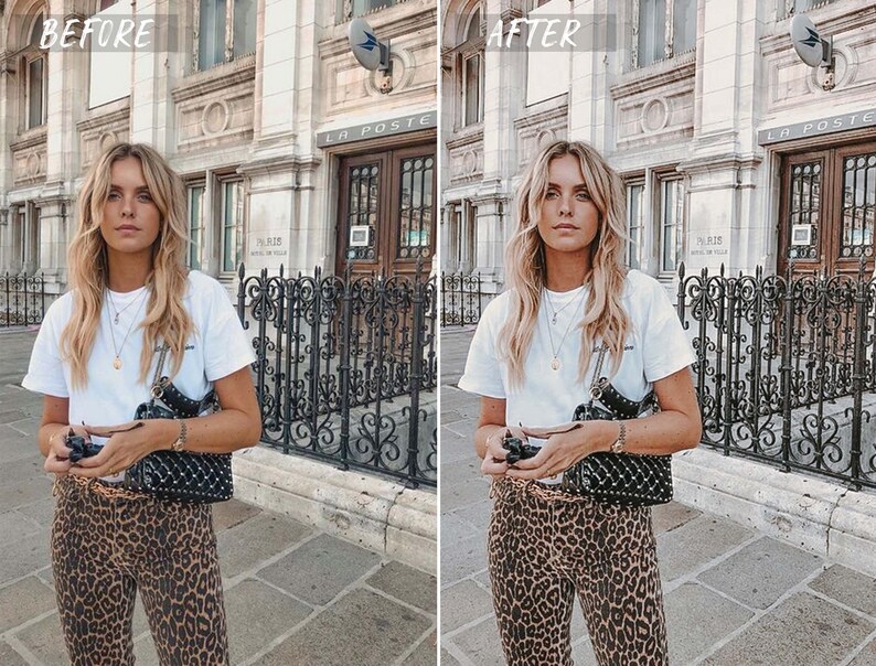 May include: A woman wearing a white t-shirt and leopard print pants stands in front of a building with a black metal fence. She is holding a black studded handbag and a camera.