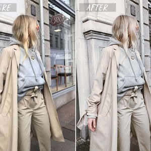 May include: A woman wearing a gray hooded sweatshirt, beige pants, and a beige trench coat. She is standing in front of a storefront with a sign that says "J&J".