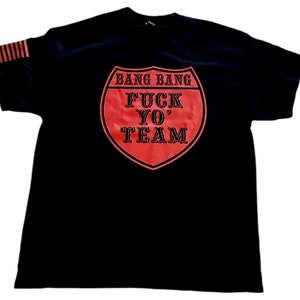 May include: Black t-shirt with a red road sign graphic that says "Bang Bang Fuck Yo' Team".