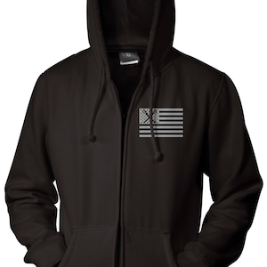 May include: Black zippered hoodie with a gray American flag design on the front. The flag has a crossed-out symbol in the center.