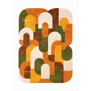 May include: A rectangular rug with a geometric pattern in shades of orange, brown, green, yellow, and cream. The design features rounded shapes and arches. The text "Bhadohi Mart" is visible in several places on the rug.